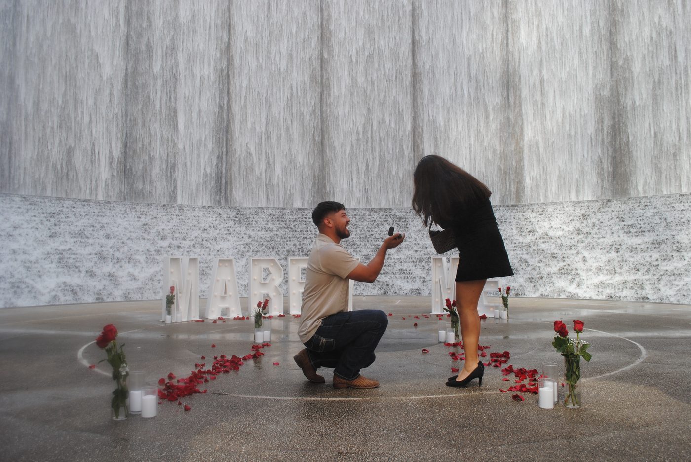 A romantic 'Marry Me' proposal with marquee letters, roses and candles